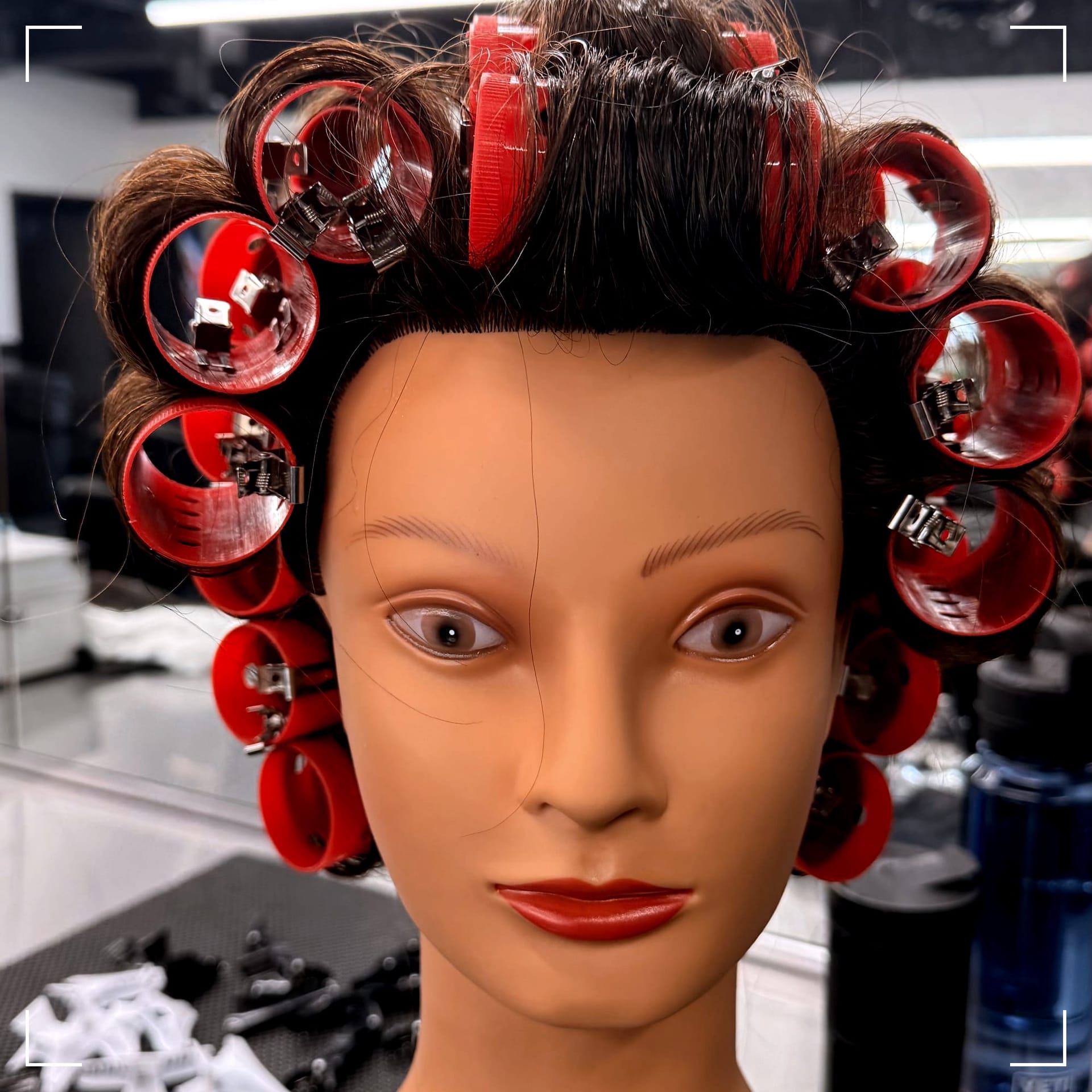 a cosmetology mannequin in 1-inch rollers from 9-sections
